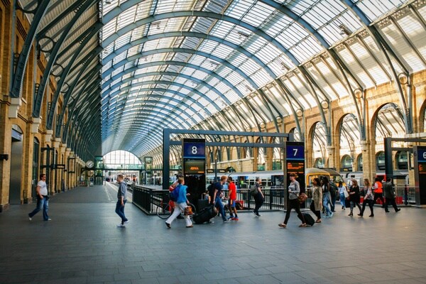 Commuters walking through railway station