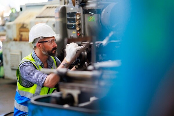 Factory engineer operating industrial machinery